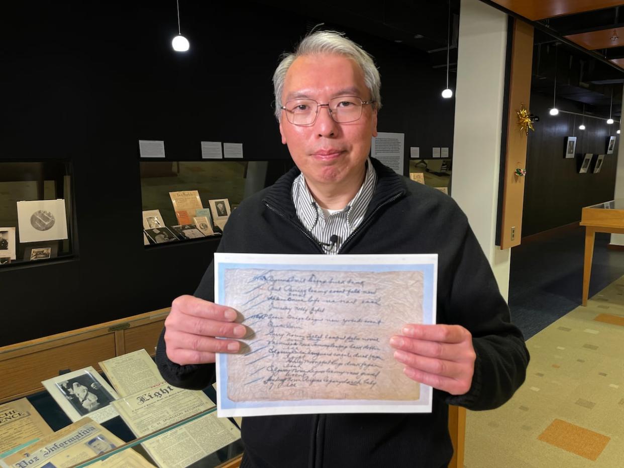 University of Manitoba research computer analyst holds a copy of the Silk Dress cryptograph. (Trevor Brine/CBC - image credit)