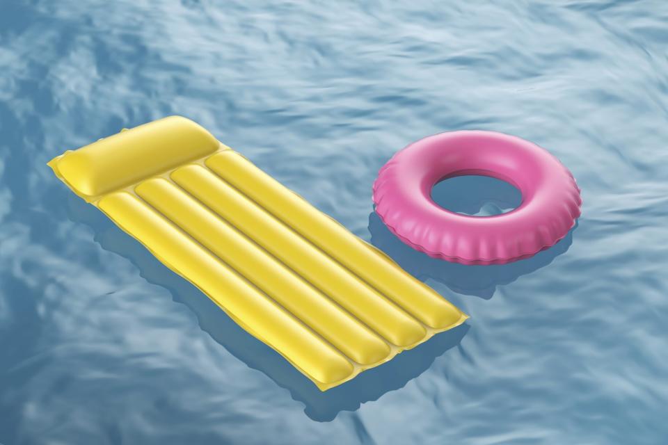 yellow and pink inflatable pool raft in pool