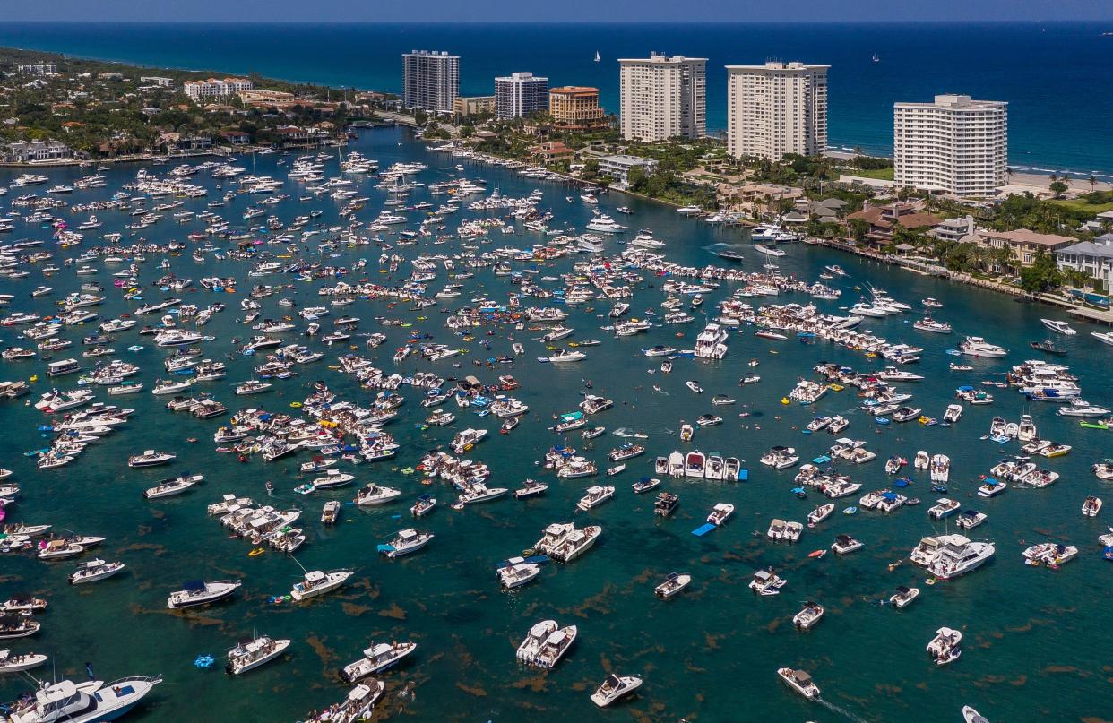 Boats fill Lake Boca Raton during the Boca Bash on Lake Boca Raton on April 28, 2019 in Boca Raton, Florida.Thousands of party-goers floated in in boats, kayaks and paddle boards in the middle of the lake. [GREG LOVETT/palmbeachpost.com]