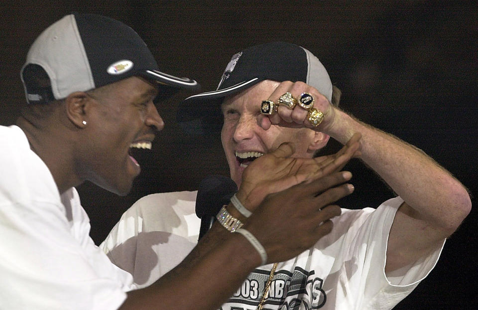 San Antonio Spurs' Steve Kerr shows his championship rings to the amazement of teammate Stephen Jackson on stage at the Alamodome, Thursday, June 18, 2003. The biggest names on the U.S. World Cup roster might be those who’ll be wearing polo shirts instead of jerseys on game days. Team USA head coach Steve Kerr is a nine-time NBA champion; five as a player, four as a coach. (Tom Reel/The San Antonio Express-News via AP)