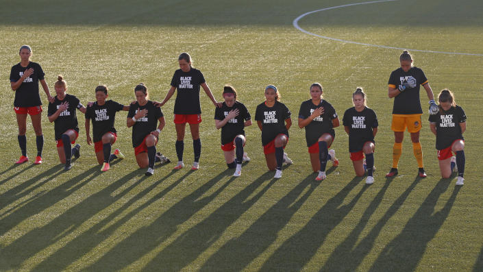 Players for the Washington Spirit kneel during the national anthem before an NWSL Challenge Cup soccer match against the Chicago Red Stars at Zions Bank Stadium, Saturday, June 27, 2020, in Herriman, Utah. (AP Photo/Rick Bowmer)