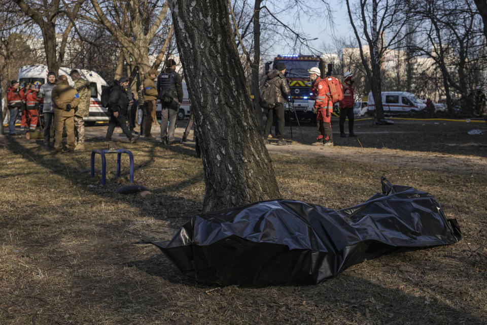 The body of a victim on the ground after a bombing in a residential area in Kyiv, Ukraine, Tuesday, March 15, 2022. Russia's offensive in Ukraine has edged closer to central Kyiv with a series of strikes hitting a residential neighborhood as the leaders of three European Union member countries planned a visit to Ukraine's embattled capital. (AP Photo/Vadim Ghirda)