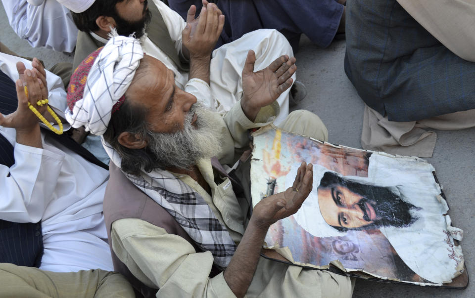 FILE - In this May 2, 2013 file photo, supporters of Pakistan's religious party pray for the slain al-Qaida leader Osama bin Laden at rally to pay tribute to him in Quetta, Pakistan. Pakistan's prime minister Imran Khan accused the United States on Thursday, June 25 2020, of having "martyred" al-Qaida leader and the mastermind of the 9/11 attacks, Osama bin Laden.(AP Photo/Arshad Butt,file)