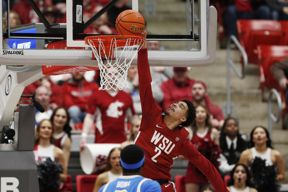 Washington State guard Myles Rice (2) dunks during the first half of an NCAA college basketball game against UCLA, Saturday, March 2, 2024, in Pullman, Wash. (AP Photo/Young Kwak)