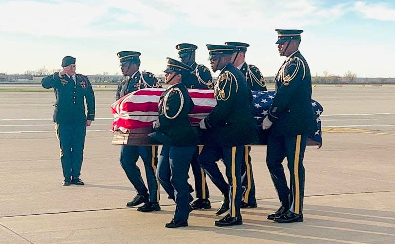 Braden Peltier’s casket is transported by military officials last week at the Detroit Airport. A more than 170-mile processional followed Braden to the funeral home in Bay City.