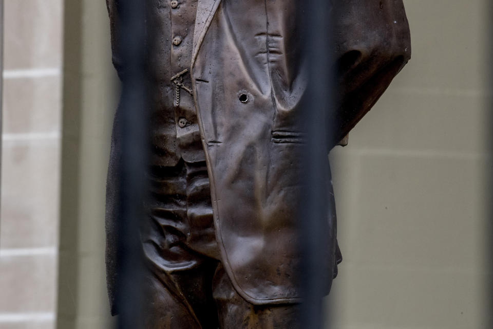 A bullet hole is visible in a statue of Cuban national hero Jose Marti after police say a person with an assault rifle opened fire at the Cuban Embassy, Thursday, April 30, 2020, in Washington. (AP Photo/Andrew Harnik)