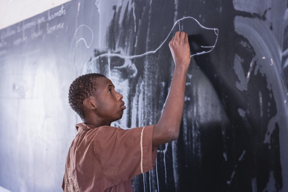 Mouhamed Sall, who is deaf, attends class at the Guinaw Rail Sud public high school in Pikine, Senegal, Monday, March 18, 2024. Sall and three other students are part of a new approach in a small number of schools in Senegal that seat those who are deaf and hard of hearing with the rest of the class. (AP Photo/Sylvain Cherkaoui)