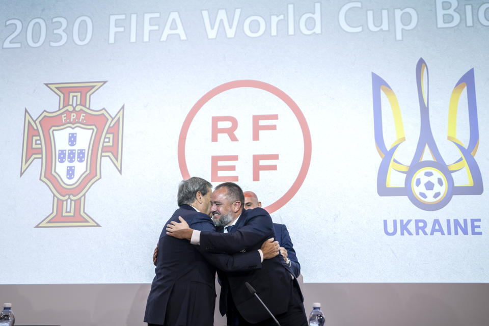 Portuguese Soccer Federation President Fernando Gomes, left, President of the Spanish Royal Federation of Soccer (RFEF), Luis Rubiales, right, Ukrainian Football Federation President Andriy Pavelko, center, welcome during a press conference about the announcing that Ukraine is joining Spain and Portugal in their joint bid to host the World Cup in 2030, at the UEFA Headquarters, in Nyon, Switzerland, Wednesday, October 5, 2022. The proposal harnesses the idea that football can restore hope and peace, while Ukraine has been at war with Russia for months. (Martial Trezzini/Keystone via AP)