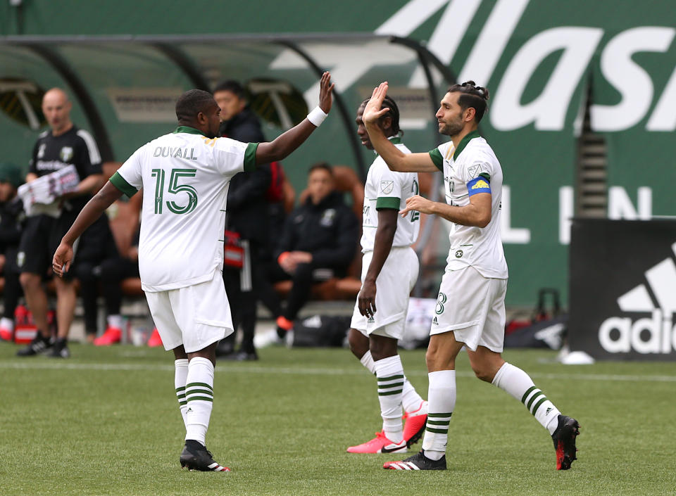 Portland Timbers' Diego Valeri, right, celebrates his goal with his teammate in an MLS soccer match against Nashville SC in Portland, Ore., Sunday, March 8, 2020. (Sean Meagher/The Oregonian via AP)