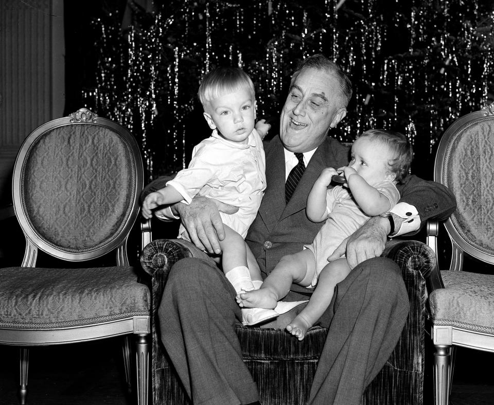 FDR holds two of his young grandchildren on Christmas in 1939.