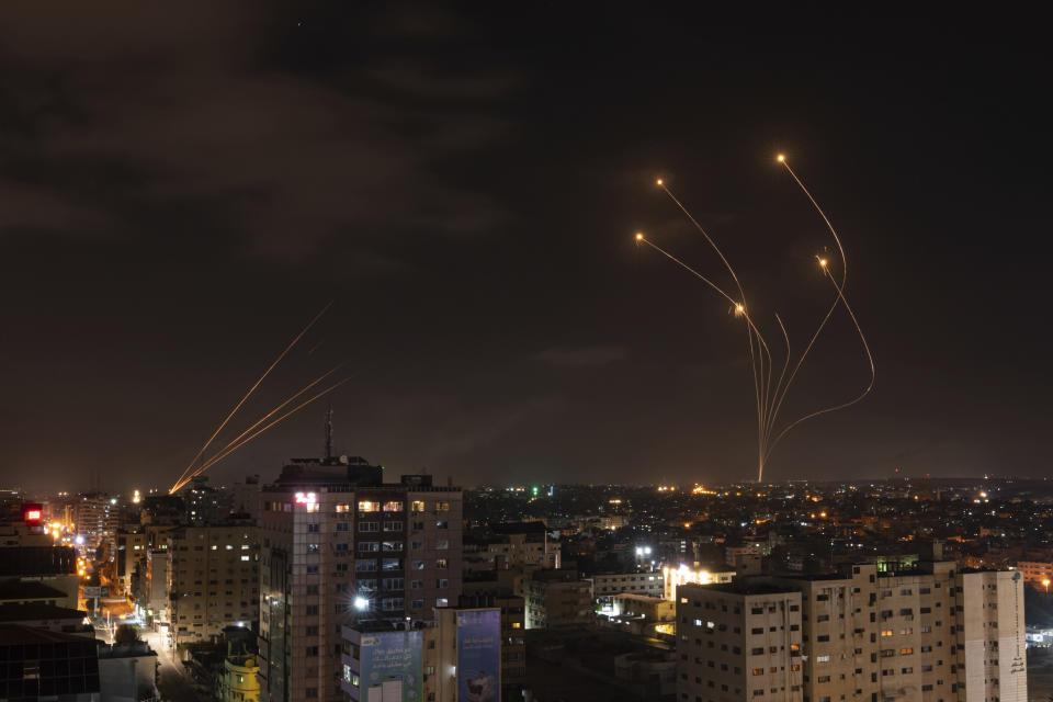 Rockets fired from Gaza and intercepted by Israel's Iron Dome anti-missile system over Israeli skies are seen from Gaza City, Saturday, May 13, 2023. (AP Photo/Fatima Shbair)