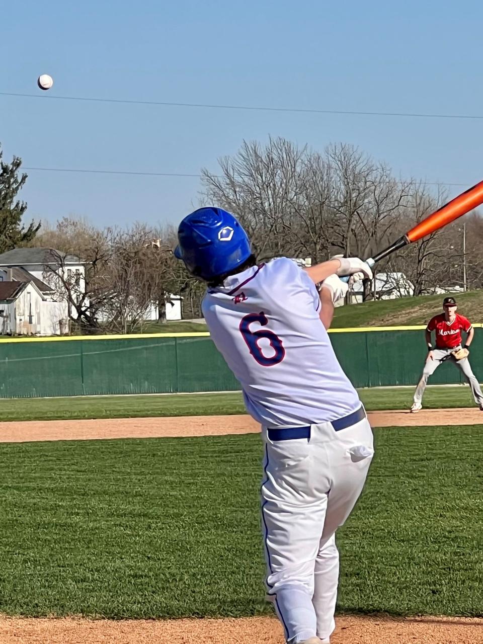 Highland senior Zach Schmidt puts the ball in play against Marion Harding in a home baseball game earlier this season.