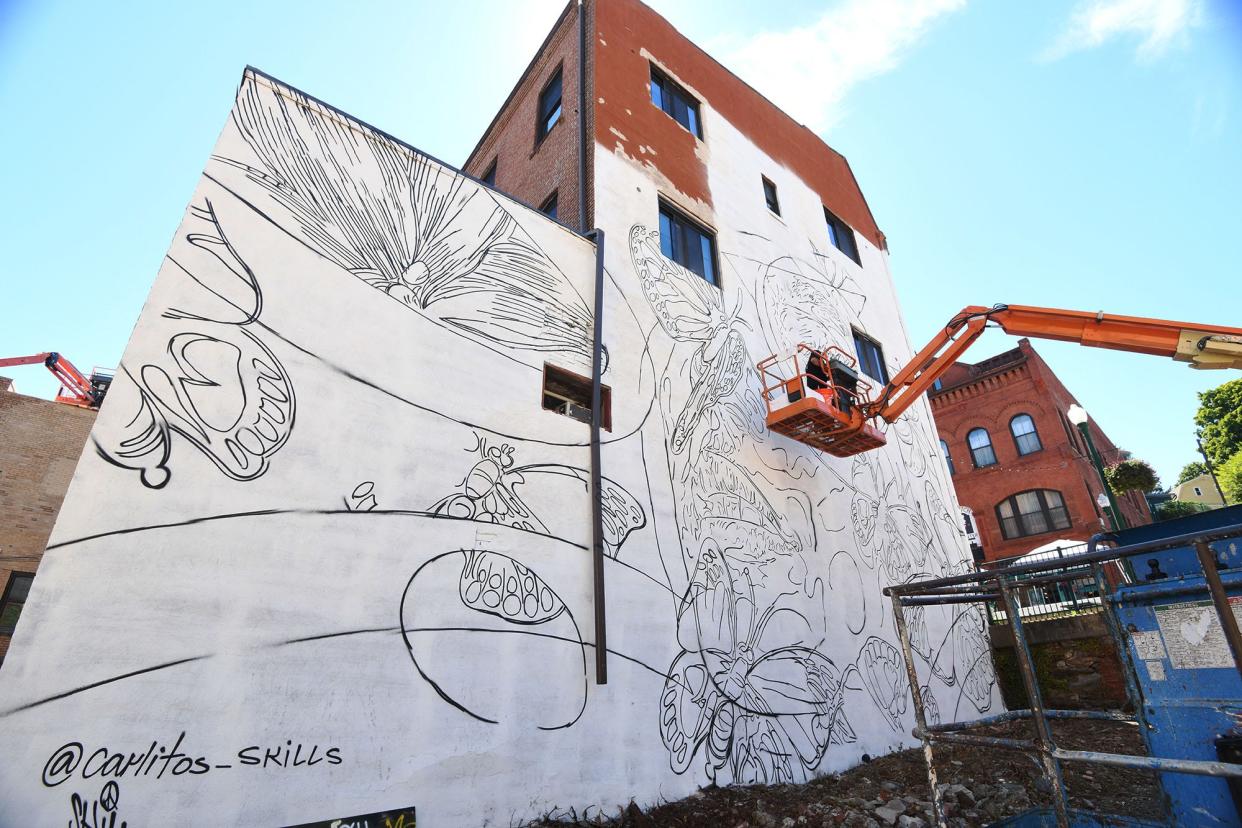 Mural artist Carlos Alexis Rivera Rivera, 31, of Puerto Rico, prepares to paint a mural on the 45-foot high by 37-foot wide wall on 59 Broadway in downtown Norwich Friday.