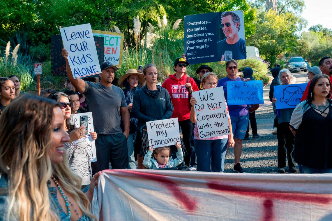 Tara Thornton, left, co-founder of Freedom Angels, stands with parents’ rights activists who rallied outside Gov. Newsom’s home to protest trans bills and what they call the “War on Children” on Saturday in Fair Oaks. Lezlie Sterling/lsterling@sacbee.com