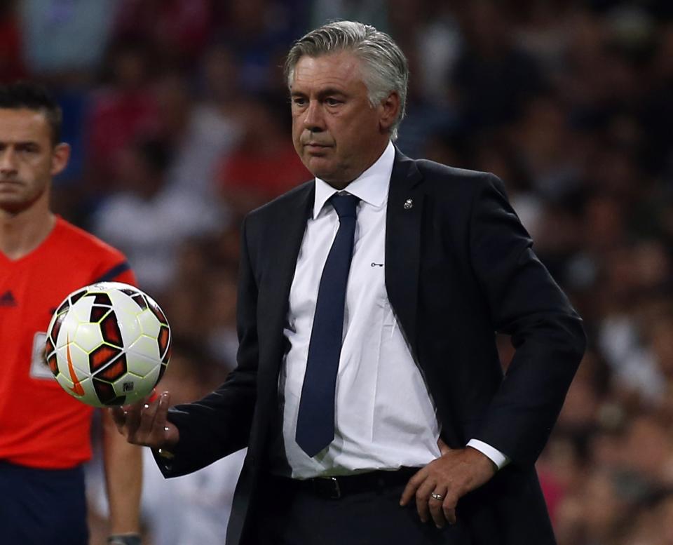 Real Madrid&#39;s coach Carlo Ancelotti holds the ball during their Spanish first division soccer match against Cordoba at Santiago Bernabeu stadium in Madrid August 25, 2014. REUTERS/Sergio Perez (SPAIN - Tags: SPORT SOCCER)