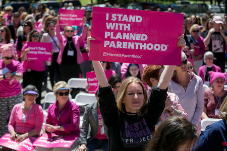 Demonstrators hold up placards during a Planned Parenthood rally outside the State Capitol in Austin, Texas, April 5, 2017. REUTERS/Ilana Panich-Linsman