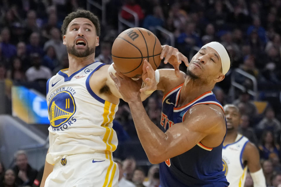 Golden State Warriors guard Klay Thompson (11) reaches for the ball next to New York Knicks guard Josh Hart during the first half of an NBA basketball game in San Francisco, Monday, March 18, 2024. (AP Photo/Jeff Chiu)