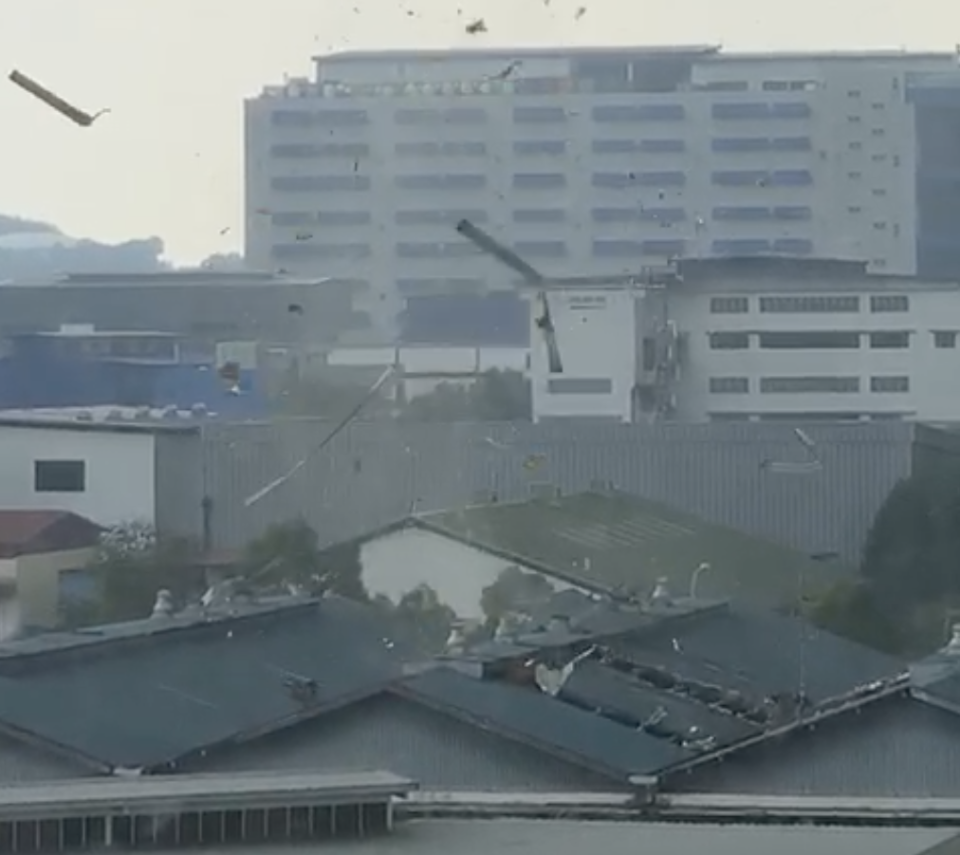 Screenshot from a video posted on social media showing a landspout ripping the roof off a building in Tuas on 27 September 2019.