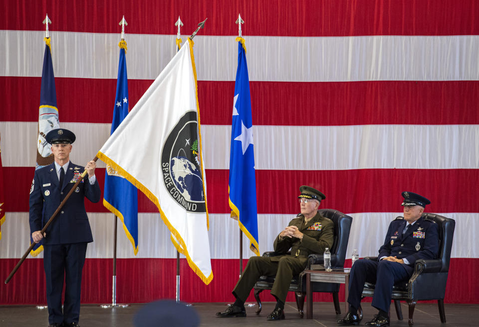 Gen. John W. Raymond, U.S. Air Force and commander of the U.S. Space Command, right, and Gen. Joseph F. Dunford, Jr., U.S. Marines and Chairman of the Joint Chiefs of Staff, watch during the presentation of the new U.S. Space Command colors Monday, Sept. 9, 2019, during a ceremony to recognize the establishment of the United States Space Command at Peterson Air Force Base in Colorado Springs, Colo. (Christian Murdock/The Gazette via AP)