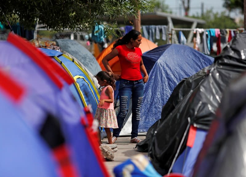 FILE PHOTO: Central American migrants are seen outside their tents in an encampment in Matamoros