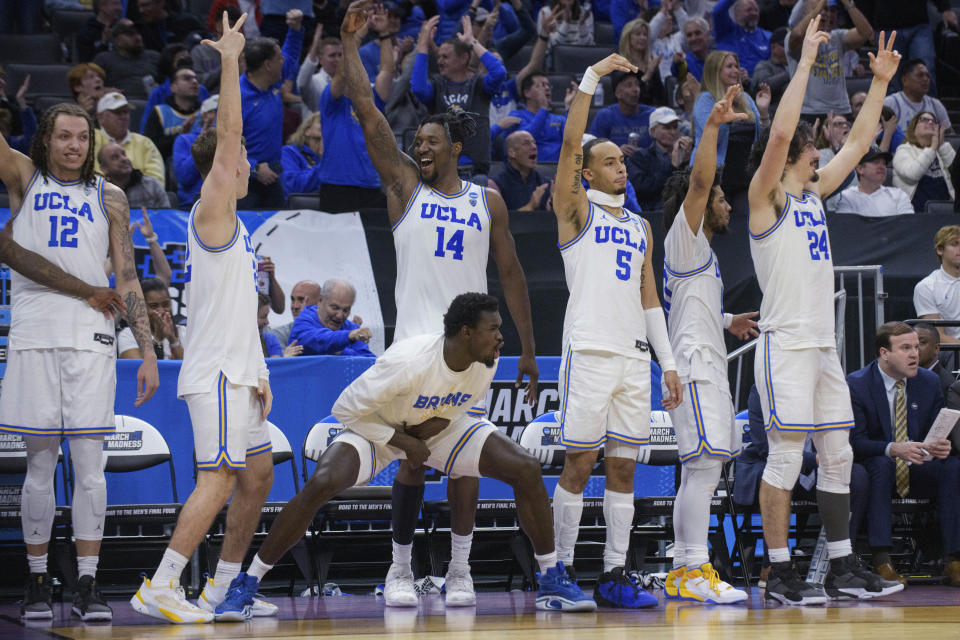 UCLA players celebrate near the end of a win in a first-round college basketball game against UNC Asheville in the men's NCAA Tournament in Sacramento, Calif., Thursday, March 16, 2023. (AP Photo/Randall Benton)