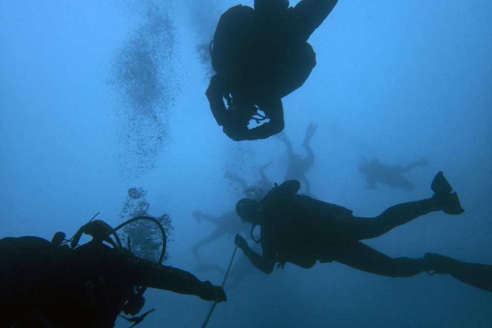 In this photo taken on Sunday, April 7, 2019, divers visit a 5th Century B.C. shipwreck, the first ancient shipwreck to be opened to the public in Greece, including to recreational divers who will be able to visit the wreck itself, near the coast of Peristera, Greece. Greece’s rich underwater heritage has long been hidden from view, off-limits to all but a select few, mainly archaeologists. Scuba diving was banned throughout the country except in a few specific locations until 2005, for fear that divers might loot the countless antiquities that still lie scattered on the country’s seabed. Now that seems to be gradually changing, with a new project to create underwater museums. (AP Photo/Elena Becatoros)