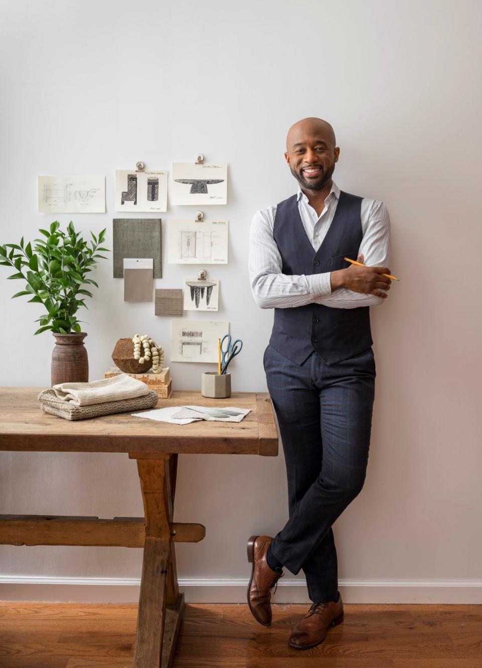 Man standing next to design sketches