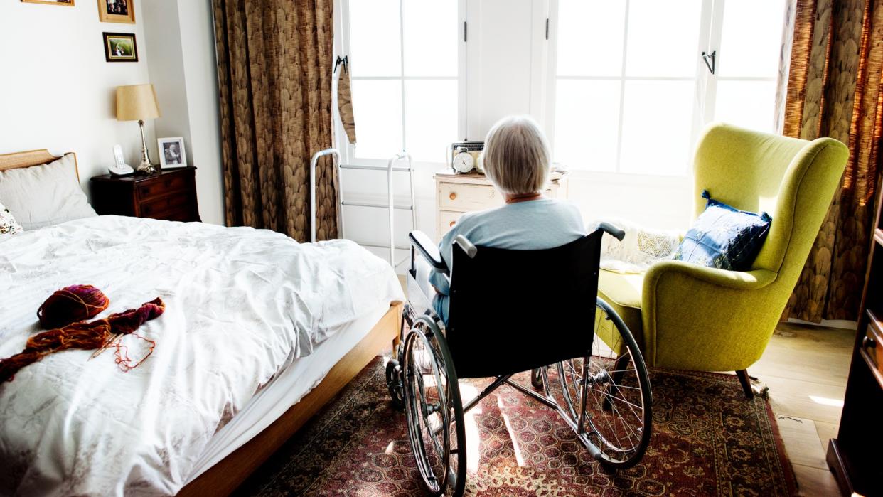 Senior woman sitting on the wheelchair alone.