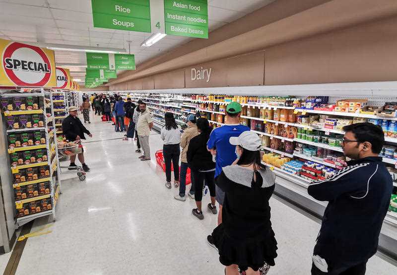 People queueing for a delivery of toilet paper, paper towel and pasta at Coles Supermarket, Epping 