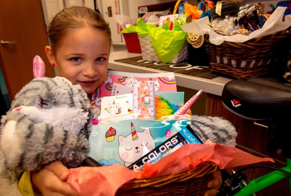 In December 2018, kindergarten student Genie Hernandez holds her favorite basket that she helped put together her school’s Santa Breakfast and silent auction fundraiser.