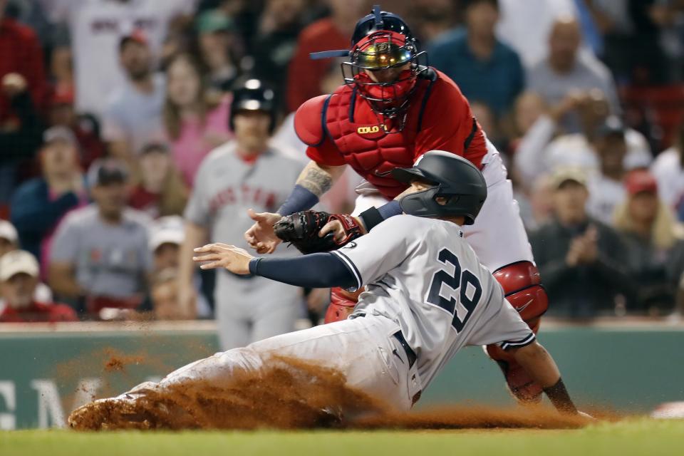 Boston Red Sox's Christian Vazquez tags New York Yankees' Gio Urshela (29) trying to score on a single by Miguel Andujar during the fourth inning of a baseball game, Friday, June 25, 2021, in Boston. (AP Photo/Michael Dwyer)