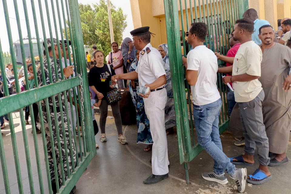 Evacuees cross into Egypt through the Argeen land port, after being evacuated from Sudan to escape the conflict, east of the High Dam Lake on the international border lines between Egypt and the Sudan, Thursday, April 27, 2023. (AP Photo)