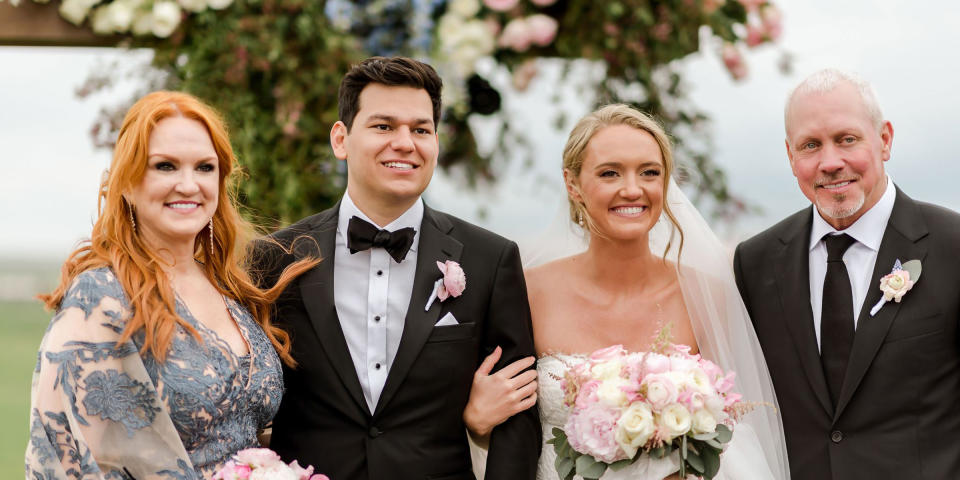 A mother and father stand proudly next to a smiling bride and groom (Courtesy of Ashley Alexander Photography)