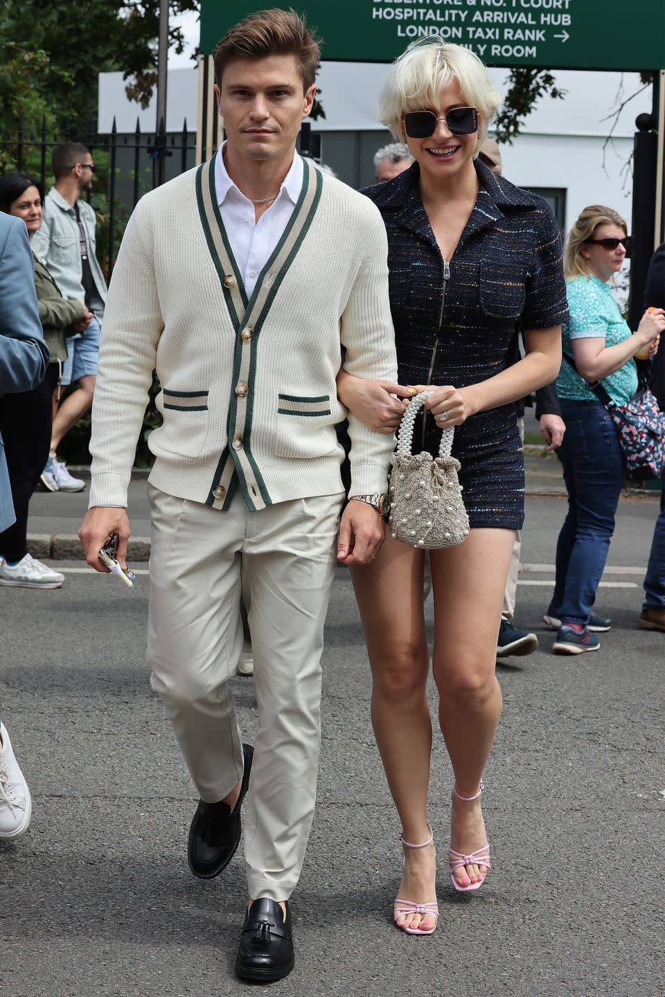 <p>Pixie Lott wore a tweed playsuit and strappy sandals, while husband Oliver Cheshire opted for a classic cream knit. </p>