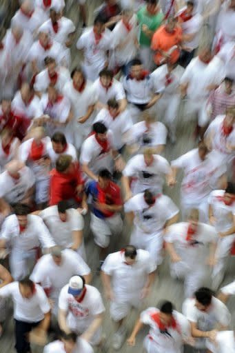 Participants run during the fourth bull run of the San Fermin Festival in the northern Spanish city of Pamplona. The six bulls from the El Pilar ranch, known for their speed, took just two minutes and 22 seconds to cover the 850-metre (2,800-foot) course, the fastest time of the four daily bull runs held so far this year