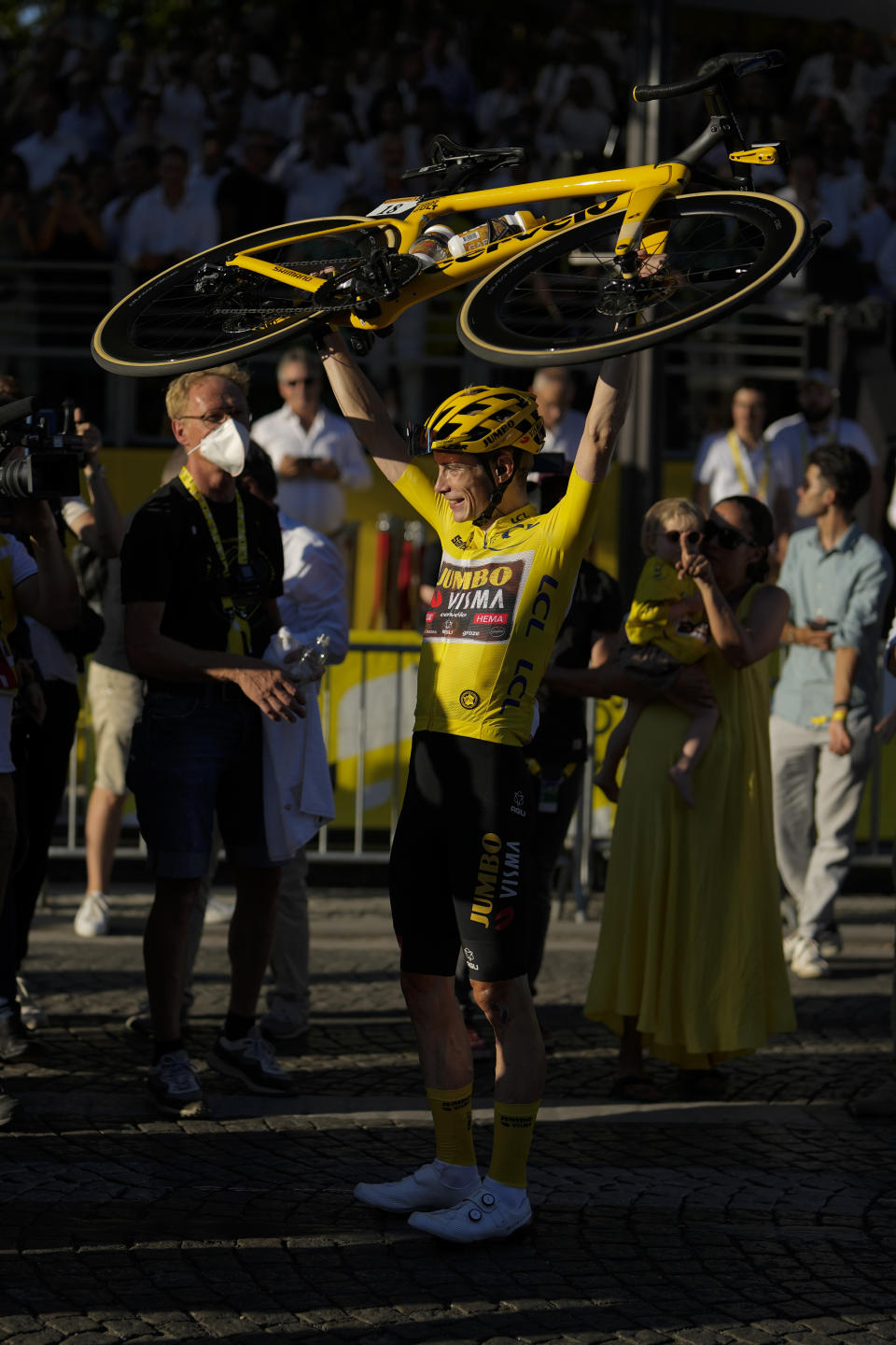 Tour de France winner Denmark's Jonas Vingegaard, wearing the overall leader's yellow jersey, celebrates after the twenty-first stage of the Tour de France cycling race over 116 kilometers (72 miles) with start in Paris la Defense Arena and finish on the Champs Elysees in Paris, France, Sunday, July 24, 2022. (AP Photo/Thibault Camus)