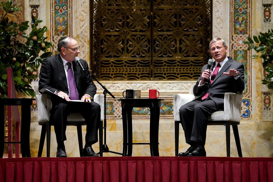 Chief Justice of the United States John Roberts (right), here during an appearance in New York City in September, ordered a brief delay in a lower court order that President Donald Trump's tax returns and financial records be turned over to Congress.