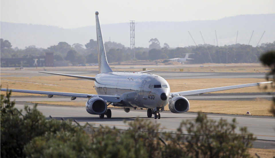 FILE - In this April 5, 2014 file photo, a U.S. Navy plane P-8 Poseidon taxies to the end of the runway for takes off from Perth Airport on route to conduct search operations for missing Malaysia Airlines Flight 370 in southern Indian Ocean, near the coast of Western Australia. Every day from the Perth airport and a nearby military base, about a dozen planes from several countries take flight to search for debris from missing Flight 370 - so far without success. The U.S. Defense Department alone committed $7.3 million to the effort in the first month of the search, much of it spent on two U.S. Navy P-8 Poseidon planes that cost $4,000 per hour to fly. (AP Photo/Rob Griffith, File)