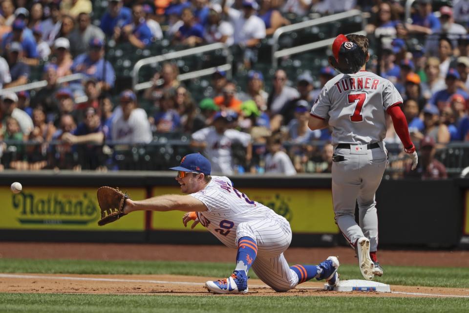 Washington Nationals' Trea Turner (7) beats the throw to first base as New York Mets' Pete Alonso (20) stretches to field the ball during the first inning of a baseball game Sunday, Aug. 11, 2019, in New York. (AP Photo/Frank Franklin II)