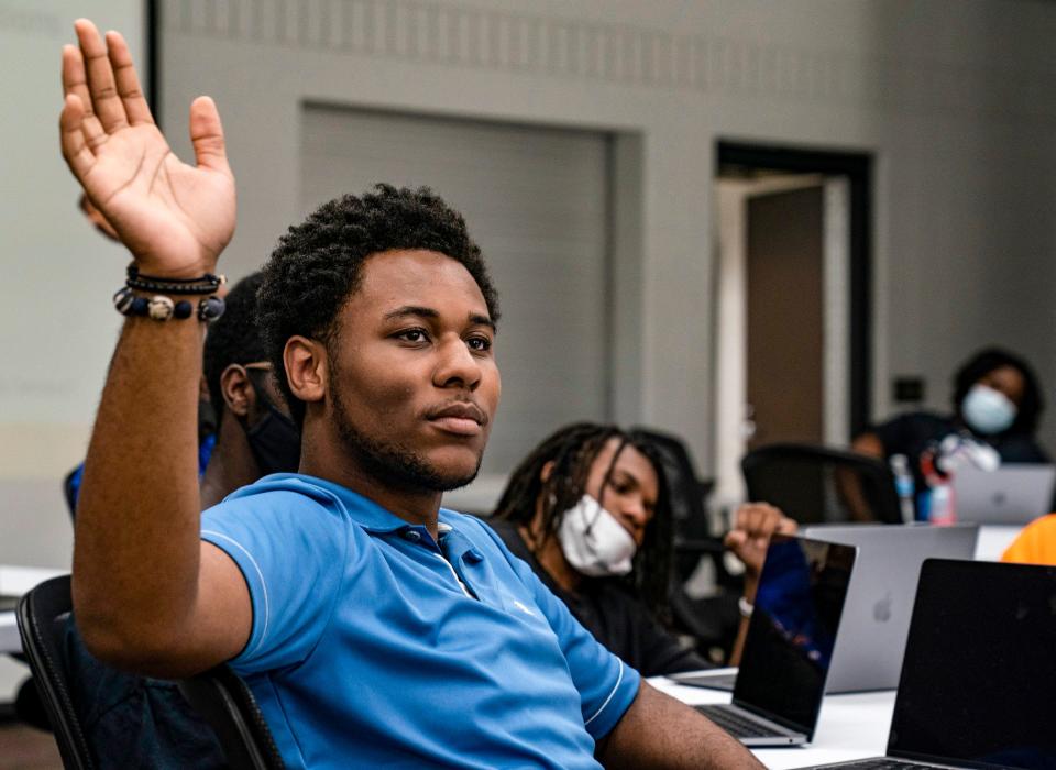 Bryant Parnell, 16, of Detroit, raises his hand to participate in a discussion during The Hidden Genius Project along\ with other students at the Dick & Sandy Dauch Campus of the Boys & Girls Club of Southeast Michigan in Detroit on Thursday, July, 7, 2022. The Hidden Genius Project is a national program with a 10-year history but Detroit is a new edition for the project this year and targets young Black men entering the ninth, 10th, and 11th grades with the goal of transforming the lives of the participants with the belief that they will be able to transform the communities they come from. The program focuses on mentorship, entrepreneurship, tech exposure, leadership, career development, etc.