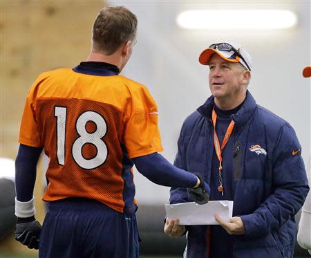 Denver Broncos quarterback Peyton Manning (L) talks with head coach John Fox during their practice session for the Super Bowl at the New York Jets Training Center in Florham Park, New Jersey January 30, 2014. REUTERS/Ray Stubblebine