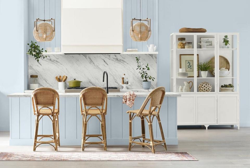 Kitchen with light blue walls and island, painted in Sherwin Williams' Upward.