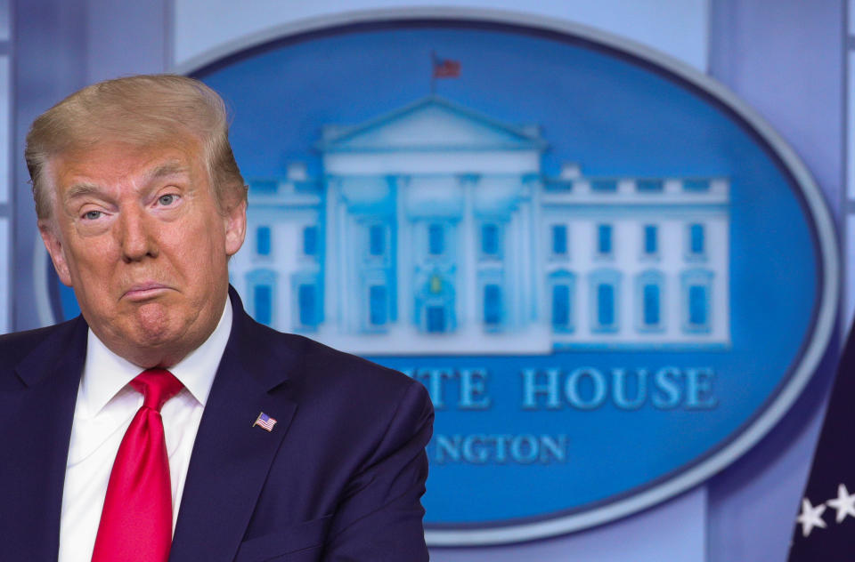 U.S. President Donald Trump speaks with U.S. Treasury Secretary Steven Mnuchin at his side during a press briefing on the U.S. economy and new U.S. employment and unemployment numbers in the Brady Press Briefing Room at the White House in Washington, U.S., July 2, 2020.  REUTERS/Tom Brenner