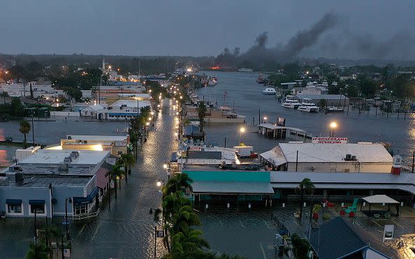 TARPON SPRINGS, FLORIDA - AUGUST 30: In an aerial view, a fire is seen as flood waters inundate the downtown area after Hurricane Idalia passed offshore on August 30, 2023 in Tarpon Springs, Florida. Hurricane Idalia is hitting the Big Bend area of Florida. (Photo by Joe Raedle/Getty Images)