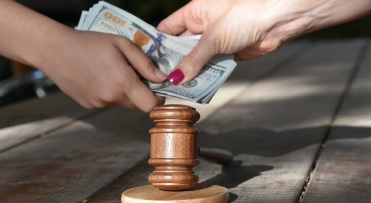 Money changing hands over a gavel