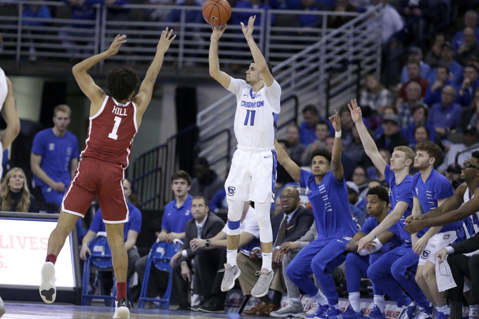 FILE - Creighton's Marcus Zegarowski (11) shoots for three points against Oklahoma's Jalen Hill (1) during the second half of an NCAA college basketball game in Omaha, Neb., in this Tuesday, Dec. 17, 2019, file photo. Zegarowski announced he's leaving Creighton and declaring for the NBA draft, the biggest name in an exodus that started after the Bluejays' run to the NCAA Sweet 16. “I will be entering the 2021 NBA draft and look forward to continuing to work hard, chase my dreams and play the game I love,” Zegarowski tweeted Tuesday, April 13, 2021. “Thank you Creighton for making my college experience so special. I will forever be a Bluejay.” (AP Photo/Nati Harnik, File)