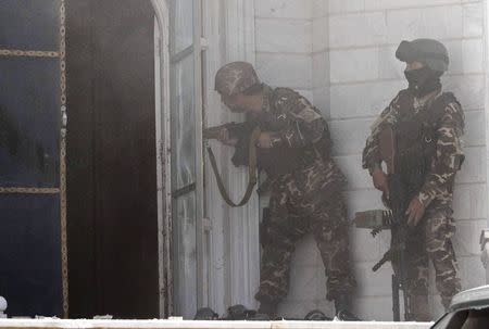 Afghan security forces take position at the scene of an attack on the Indian consulate in Herat province May 23 ,2014. REUTERS/Mohammad Shoib