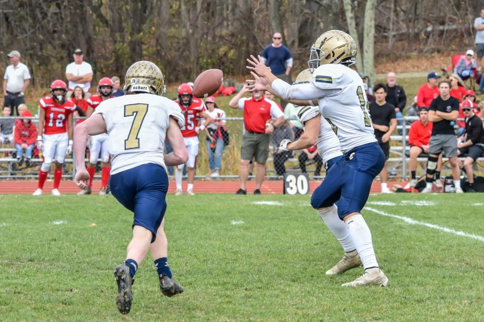 Essex's quarterback, Carter Crete receives the ball during the Hornets' D-I football semifinal vs. the CVU Redhawks last fall.