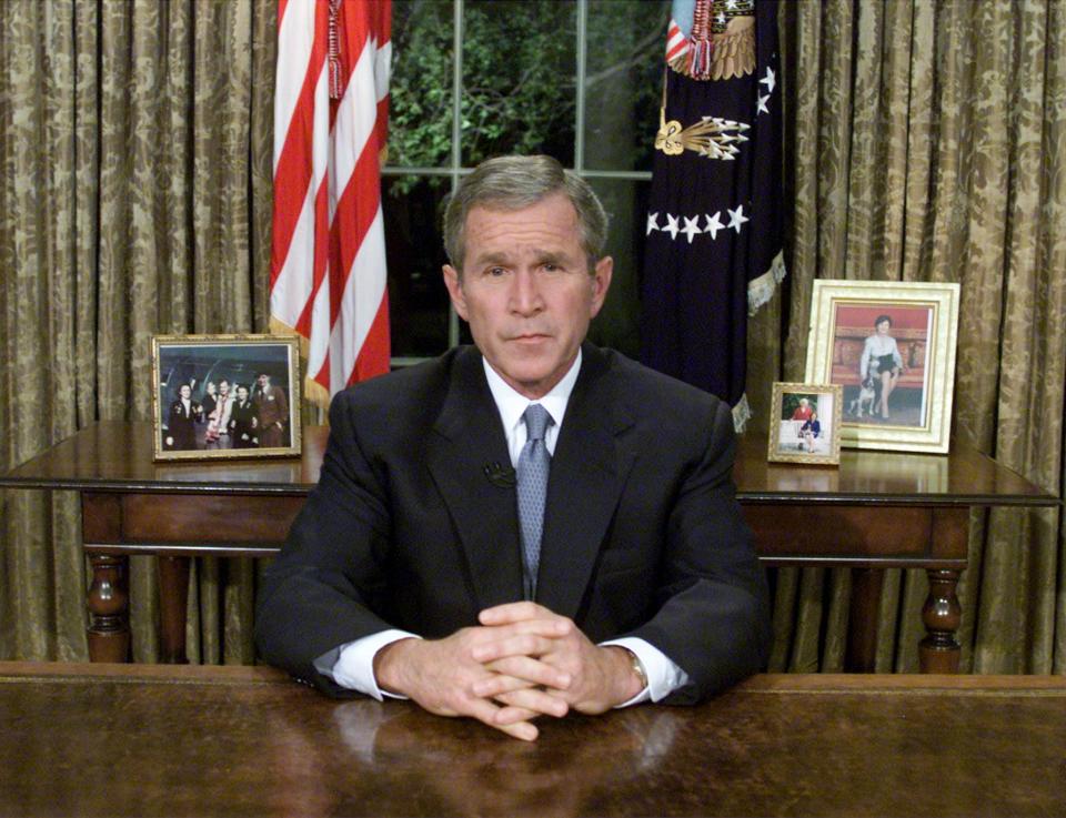 President George W. Bush sits at his desk in the Oval Office after addressing the nation about the terrorist attacks on New York and Washington, DC on September 11, 2001 in Washington, DC. (Photo: Mark Wilson/Getty Images)