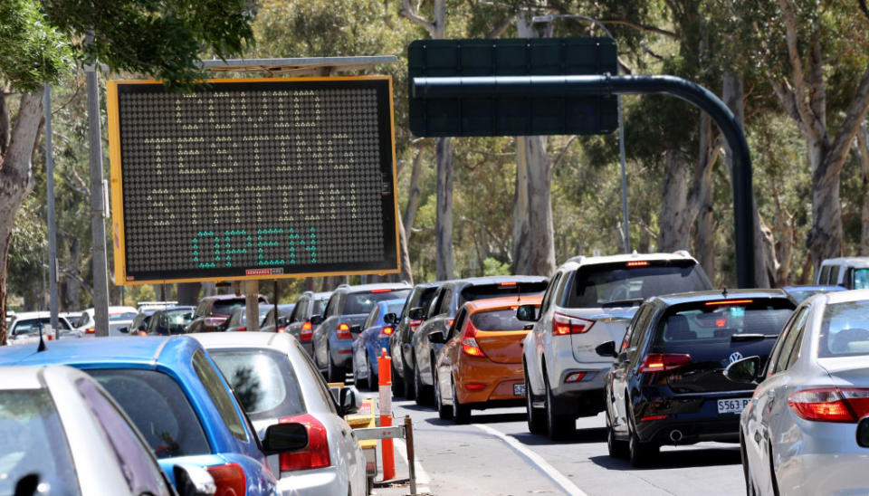 Cars queue for the COVID-19 testing facility at Victoria Park, just outside the Adelaide CBD on Monday. Source: Getty